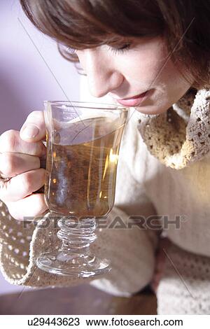 Woman drinking glass mug of tea, close up View Large Photo Image Stock Image - Woman drinking glass mug of tea, close up. Fotosearch