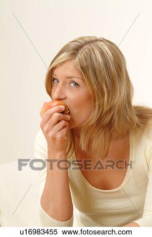 Stock Photography - Woman eating apple. Fotosearch