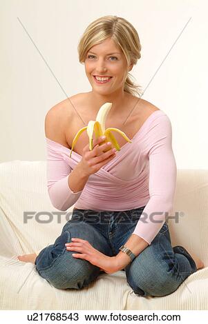 Woman on sofa eating banana View Large Photo Image Stock Image - Woman on sofa eating banana. Fotosearch