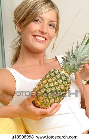 Stock Photo - Woman with pineapple. Fotosearch