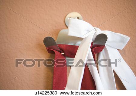 Apron straps hanging on a stainless steel hook, close up View Large Photo Image Stock Image - Apron straps hanging on a stainless steel hook, close up. Fotosearch