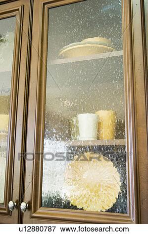 Stock Photo - China in Glass Front Cabinet. Fotosearch