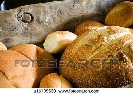 Stock Image - Freshly Baked Bread in Wood Bowl. Fotosearch