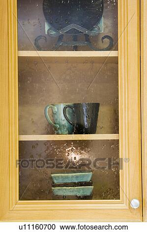 Stock Image - Glass Front Kitchen Cabinet. Fotosearch