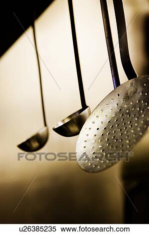 Stock Photography - Ladles Hanging from Shelf. Fotosearch