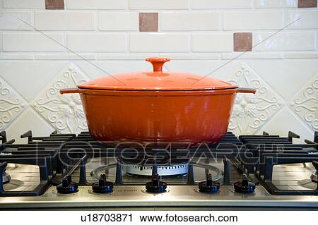 Orange cooking pot on stove top. View Large Photo Image Stock Image - Orange cooking pot on stove top.. Fotosearch
