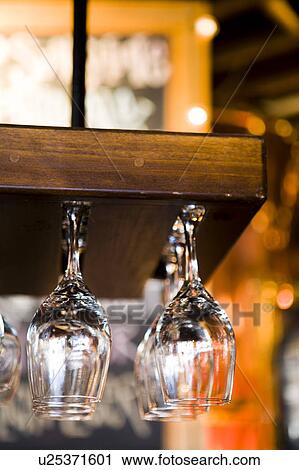 Stock Image - Wine Glass Display Hanging From Ceiling. Fotosearch