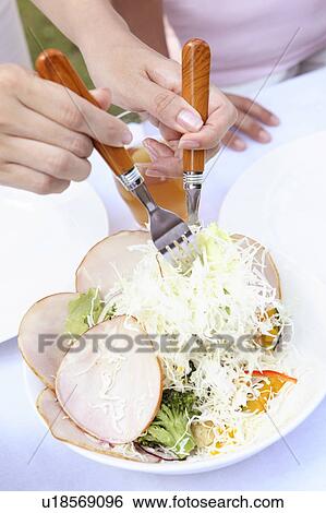 Stock Photograph - Hand serving salad. Fotosearch