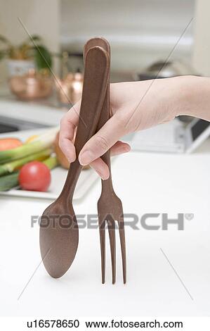 Hand with a spoon and a fork View Large Photo Image Stock Image - Hand with a spoon and a fork. Fotosearch