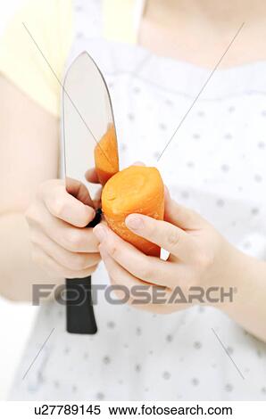 Hands peeling carrot View Large Photo Image Stock Photography - Hands peeling carrot. Fotosearch