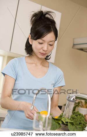 Scene of woman cooking View Large Photo Image Stock Photo - Scene of woman cooking. Fotosearch