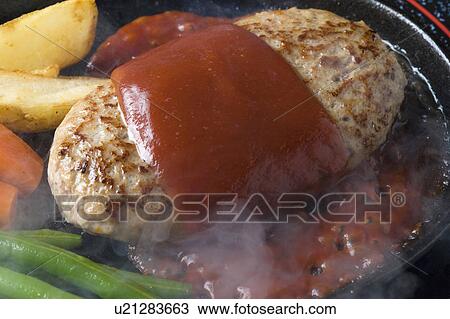 Stock Image - Hamburger and vegetables frying. Fotosearch
