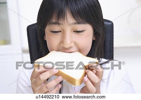 Girl eating bread View Large Photo Image Stock Image - Girl eating bread. Fotosearch