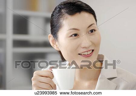 Stock Photography - Business lady who drinks coffee. Fotosearch