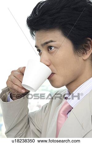Stock Image - Businessman drinking a cup of coffee. Fotosearch