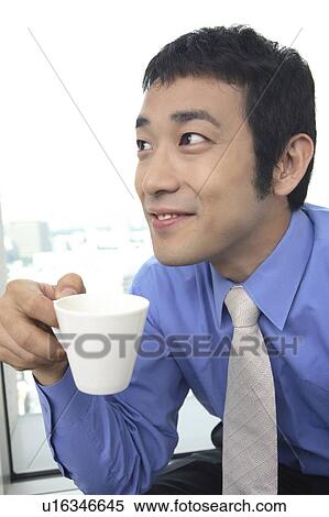 Stock Photography - Businessman drinking a cup of coffee. Fotosearch