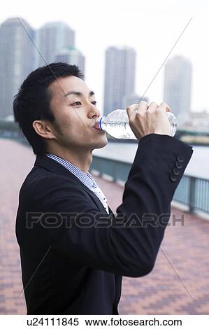 Businessman drinking water View Large Photo Image Stock Photography - Businessman drinking water. Fotosearch