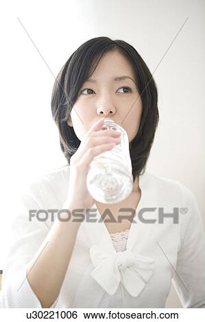 Stock Photograph - Woman drinking a bottle of water. Fotosearch