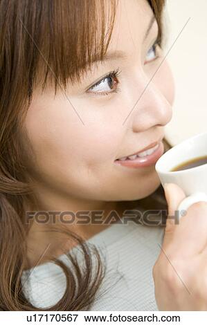 Woman drinking a cup of coffee View Large Photo Image Stock Photo - Woman drinking a cup of coffee. Fotosearch