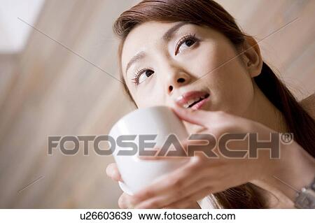Stock Photo - Woman who drinks coffee. Fotosearch
