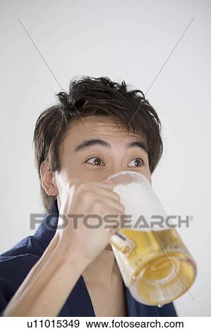 Stock Photo - Yukata man who drinks beer. Fotosearch