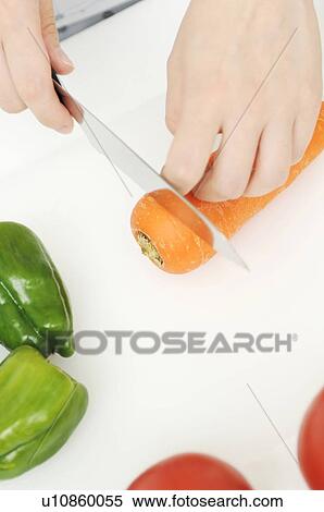 Hands cutting carrot View Large Photo Image Stock Photography - Hands cutting carrot. Fotosearch