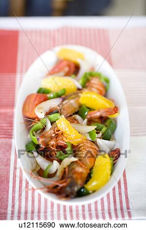Stock Image - Shrimp saute with orange. Fotosearch