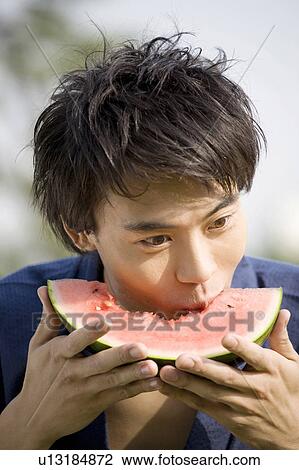 Yukata man who eats a watermelon View Large Photo Image Stock Image - Yukata man who eats a watermelon. Fotosearch