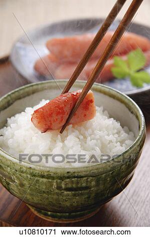 Stock Image - Spicy cod roe on top of steamed rice. Fotosearch