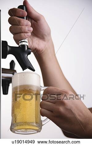 A man pouring beer into glass View Large Photo Image Stock Photo - A man pouring beer into glass. Fotosearch