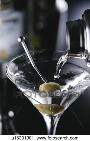 Stock Image - Cocktail pouring into glass. Fotosearch