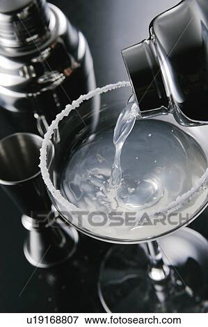 Stock Photo - Cocktail pouring into glass. Fotosearch