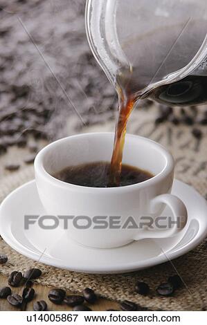 Stock Photo - Coffee pouring into coffee cup. Fotosearch