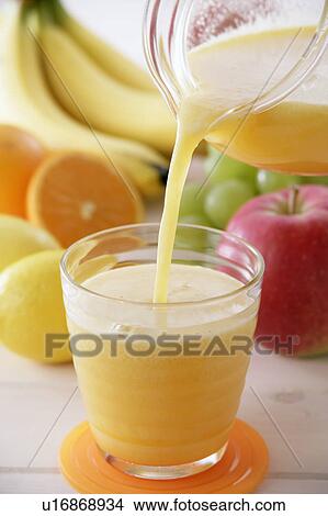 Fruit juice pouring into glass View Large Photo Image Picture - Fruit juice pouring into glass. Fotosearch