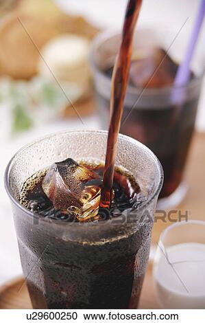Stock Image - Iced coffee pouring into glass. Fotosearch