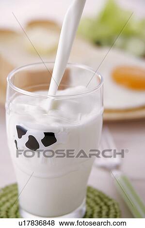 Stock Photo - Milk pouring into glass. Fotosearch