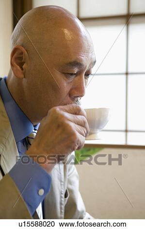 Stock Image - Senior man drinking coffee. Fotosearch