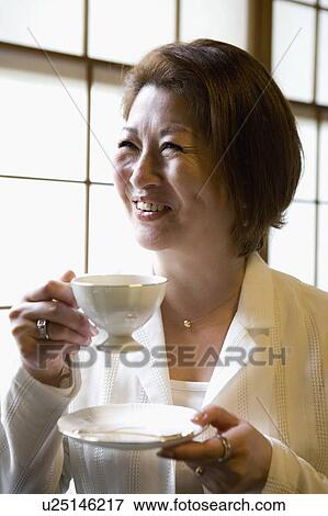Stock Photo - Senior woman drinking coffee. Fotosearch