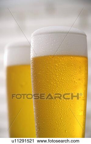 Two glasses of beer View Large Photo Image Stock Image - Two glasses of beer. Fotosearch