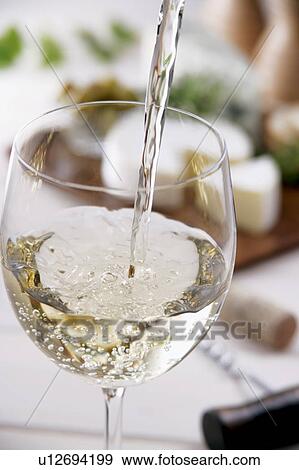White wine pouring into glass View Large Photo Image Stock Photo - White wine pouring into glass. Fotosearch