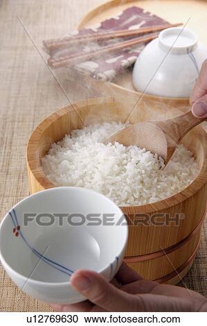 A woman serving steamed rice View Large Photo Image Stock Image - A woman serving steamed rice. Fotosearch