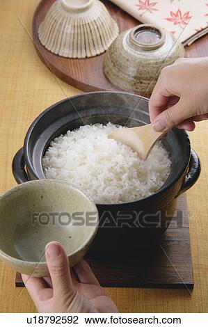 A woman serving steamed rice View Large Photo Image Stock Image - A woman serving steamed rice. Fotosearch