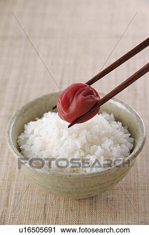 Stock Image - Pickled plum and steamed rice. Fotosearch