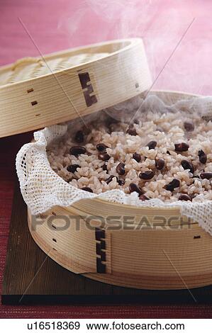 Stock Photo - Steamed red rice with beans, close-up. Fotosearch