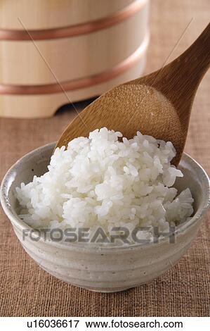 Stock Photo - Steamed rice and rice paddle. Fotosearch