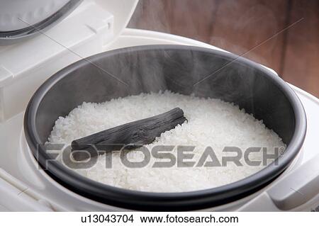 Picture - Steamed rice in rice cooker. Fotosearch