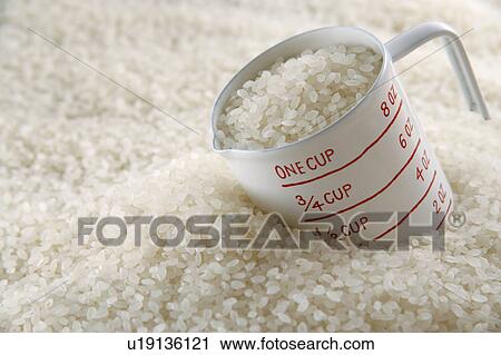 Uncooked rice and measuring jug View Large Photo Image Stock Image - Uncooked rice and measuring jug. Fotosearch