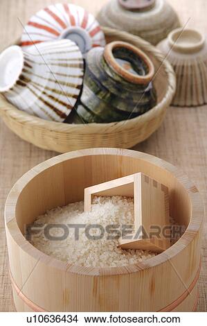 Uncooked rice in a bamboo tub and rice bowls View Large Photo Image Picture - Uncooked rice in a bamboo tub and rice bowls. Fotosearch