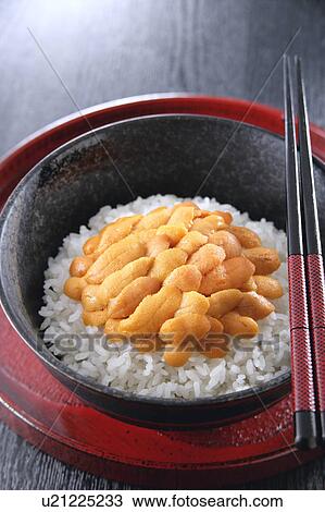 Stock Image - Sea urchin on rice in bowl. Fotosearch