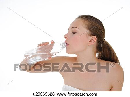 Close-up of a young woman drinking water from a water bottle View Large Photo Image Stock Photo - Close-up of a young woman drinking water from a water bottle. Fotosearch